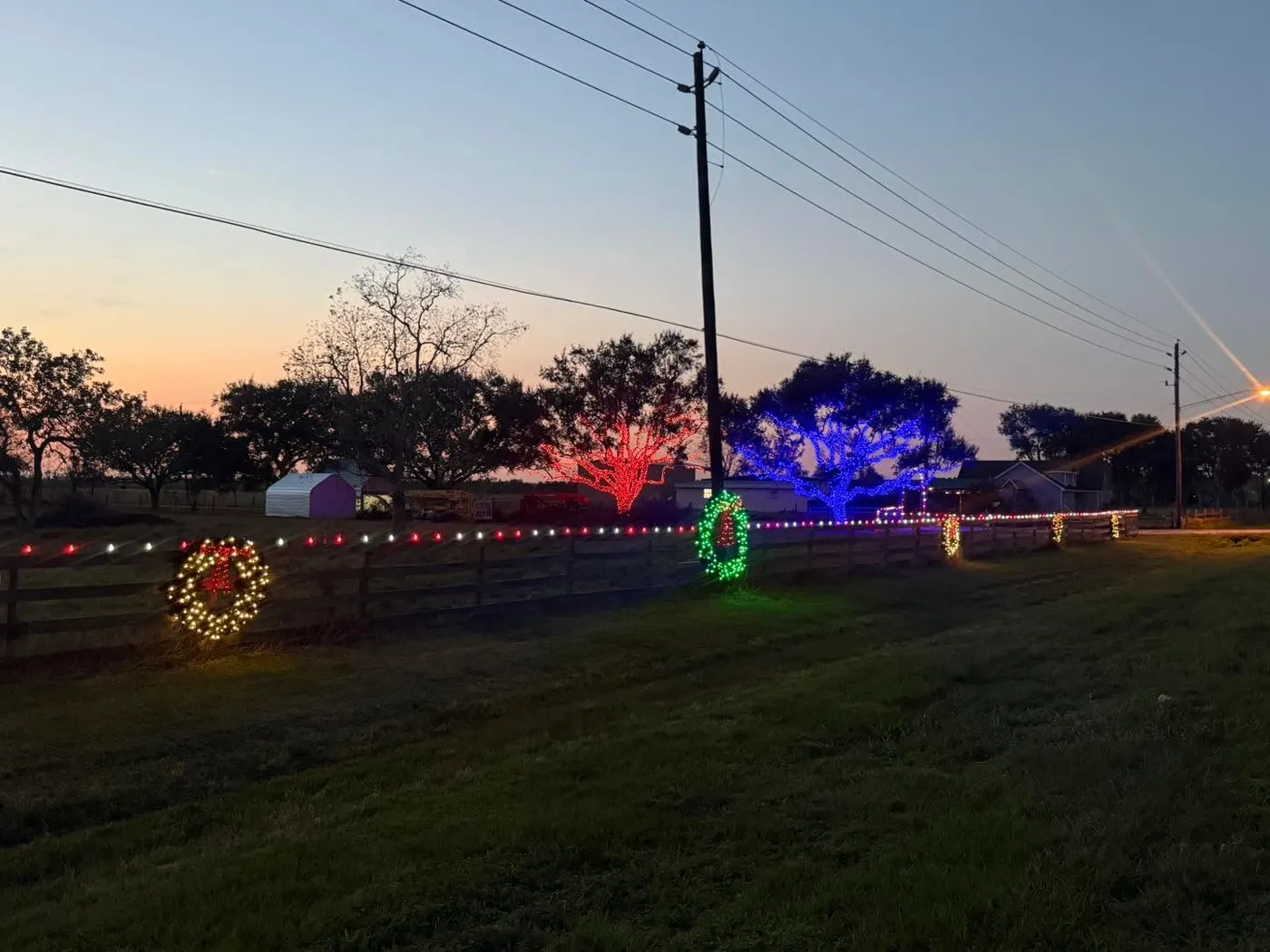 Christmas lighting on a fence with wreaths