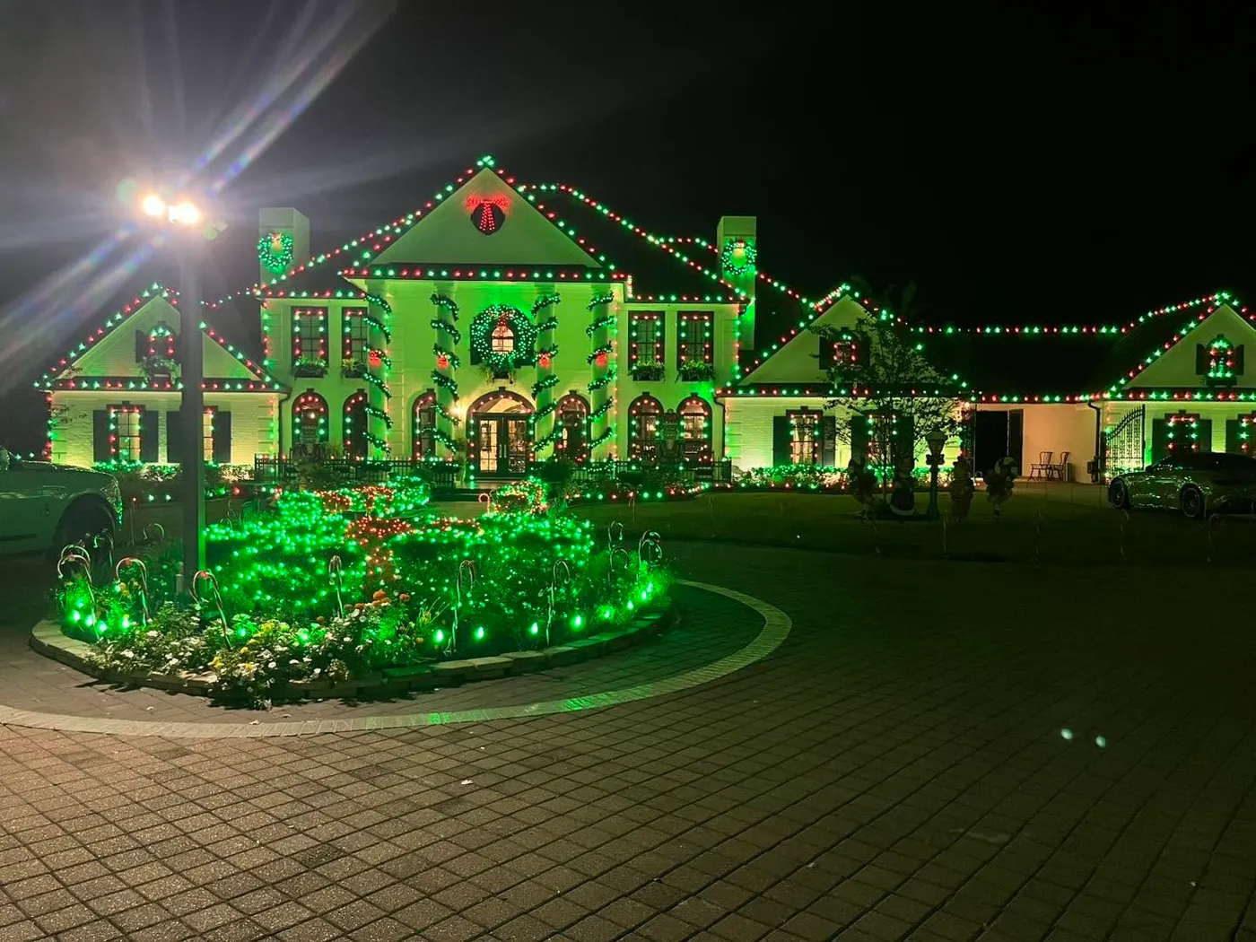 Largest date outlined in Christmas lights with green lighting on surface