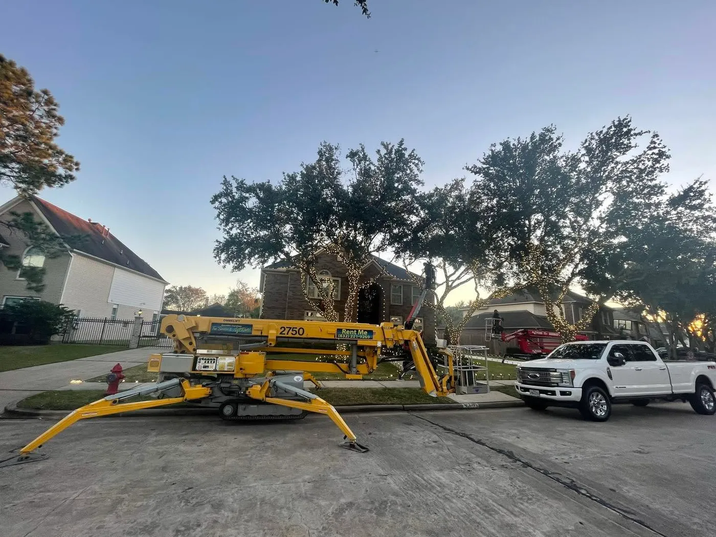 Christmas light installation with man lift boom