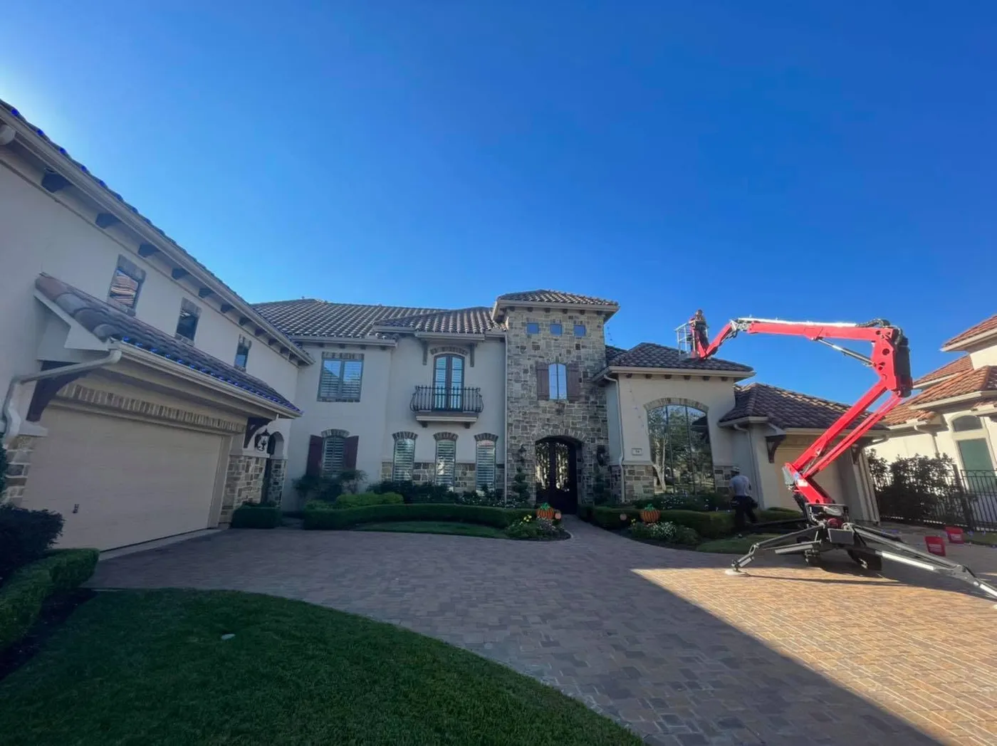 Beginning of Christmas light install on Spanish-style house